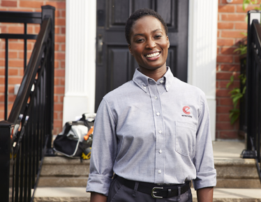 Enercare technician in front of a house