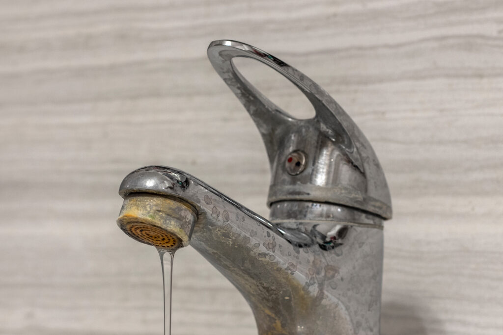 Bathroom faucet with hard water stains on it